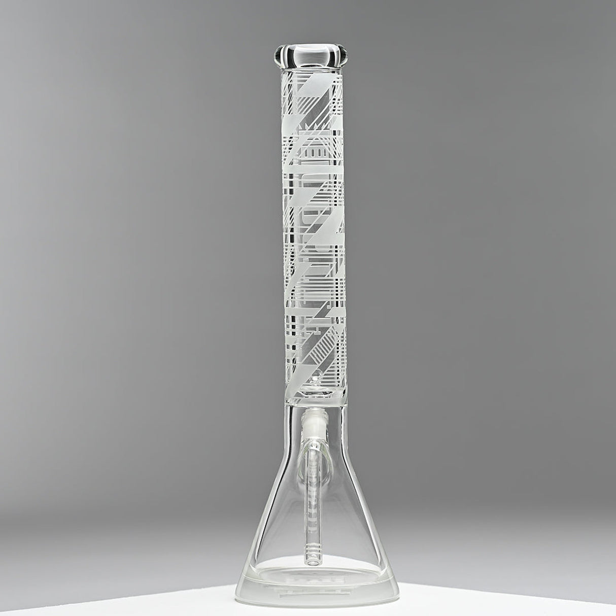 18 Glass Beaker Bong - Lines featuring intricate white etched designs on borosilicate glass, with a wide base for stability and a white cap.