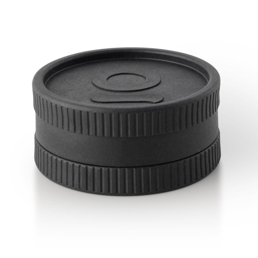 Hemp Biodegradable Grinder - Black: A compact, black, circular grinder with a discreet design, featuring a logo and durable teeth for consistent grinding.