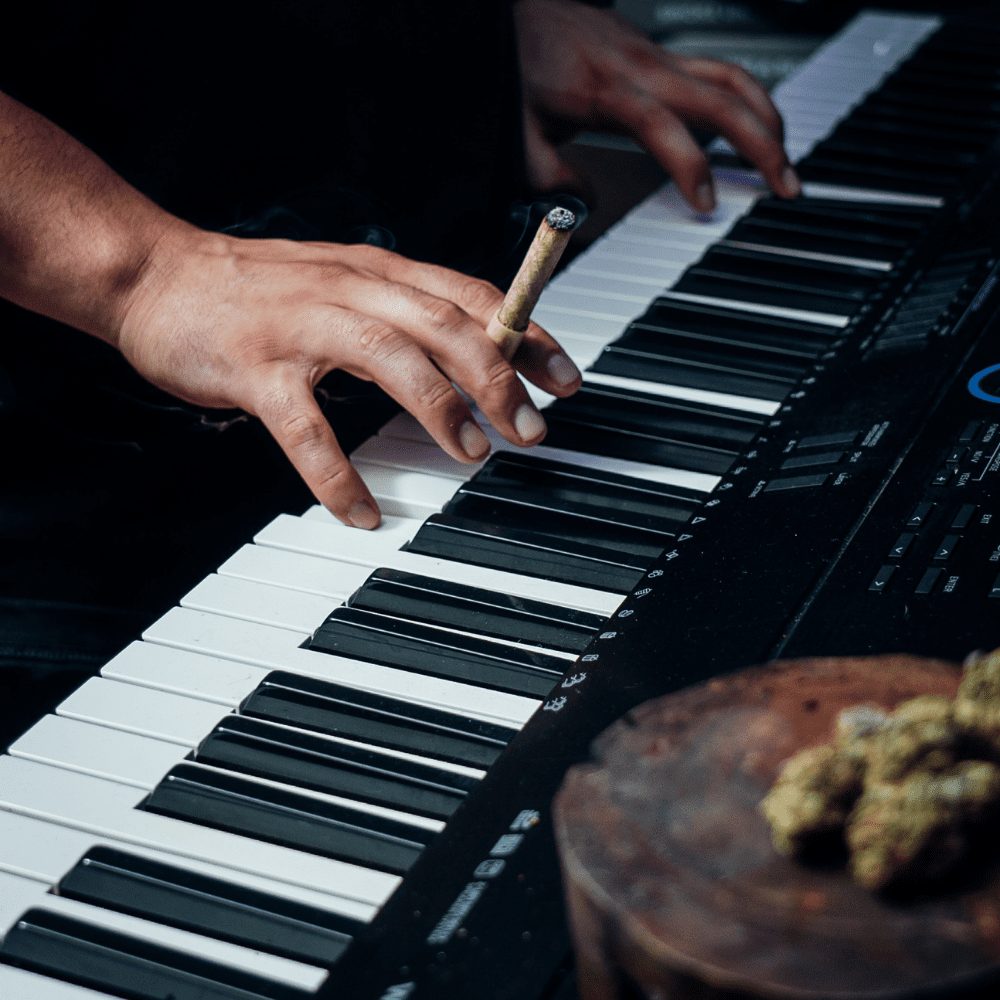 Personal CannaMold - Fits 2-4g: A person plays piano while showcasing the compact mold, ideal for crafting slow-burning cannagars with smooth airflow for premium smoking experiences.