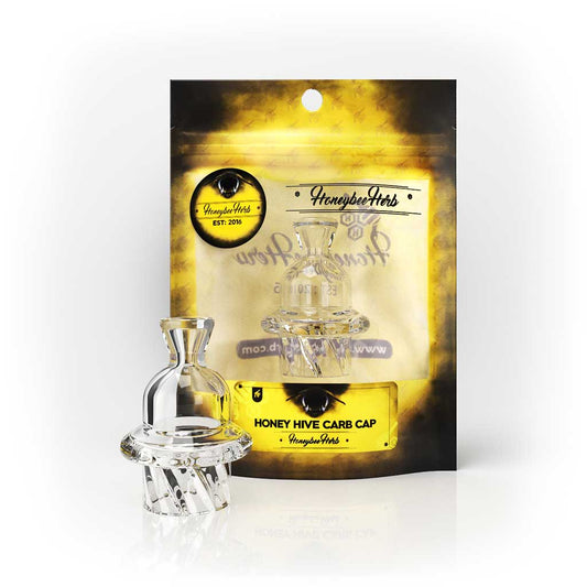 Honey Hive Carb Cap, a clear glass object with a gold cap, designed for dabbing, showcasing a vortex spinner for enhanced airflow and efficiency.