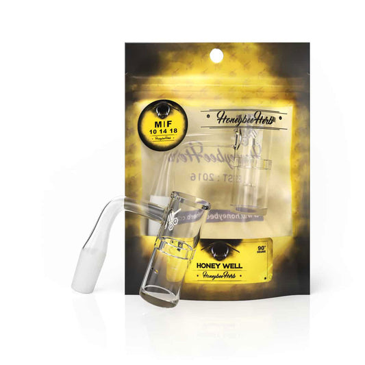 Glass bong with yellow label, showcasing the Honeybee Herb Yellow Line Honey Well Quartz Banger, XL Slurper Style, featuring a vortex airflow design for enhanced dabbing.