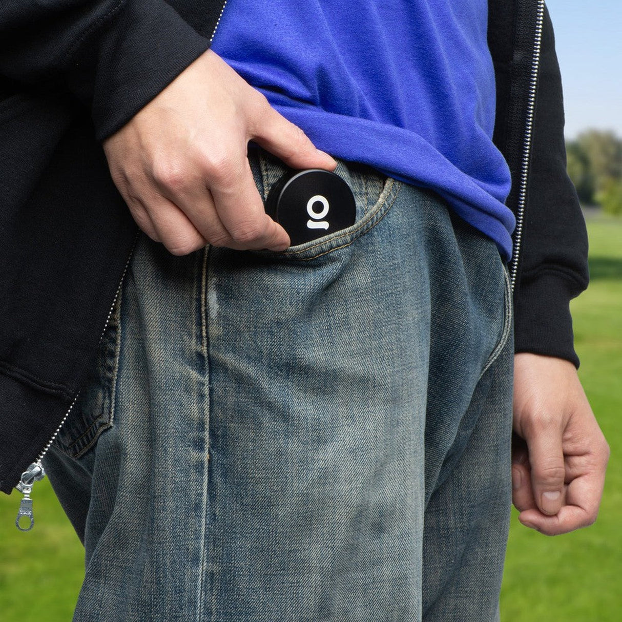 2pcs Metal 2 Magnetic Grinder being placed in a denim pocket, showcasing its compact, portable design suitable for on-the-go use.