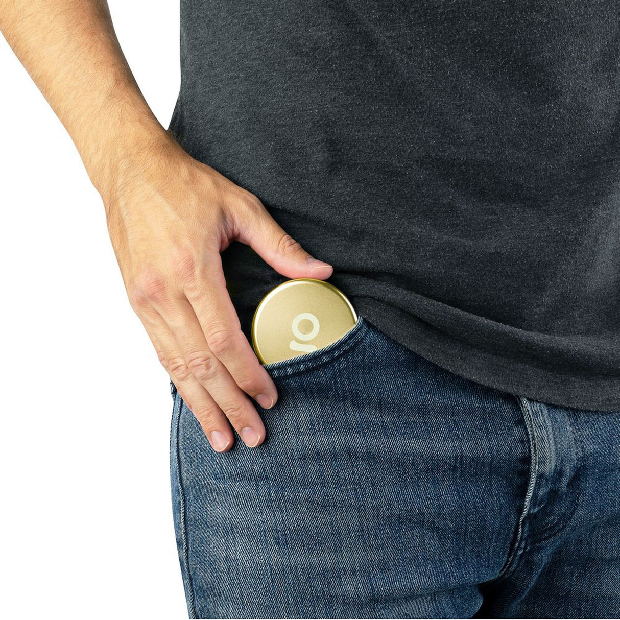 A person places an Aluminum Storage Puck into their jeans pocket, showcasing its compact, discreet design suitable for on-the-go storage.