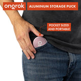 Hand placing the Aluminum Storage Puck in denim pocket, emphasizing its compact, airtight design for discreet on-the-go storage.