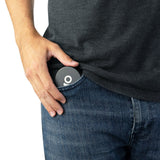 Hand placing an Aluminum Storage Puck into a jeans pocket, highlighting its compact and discreet design ideal for storing small items securely on-the-go.