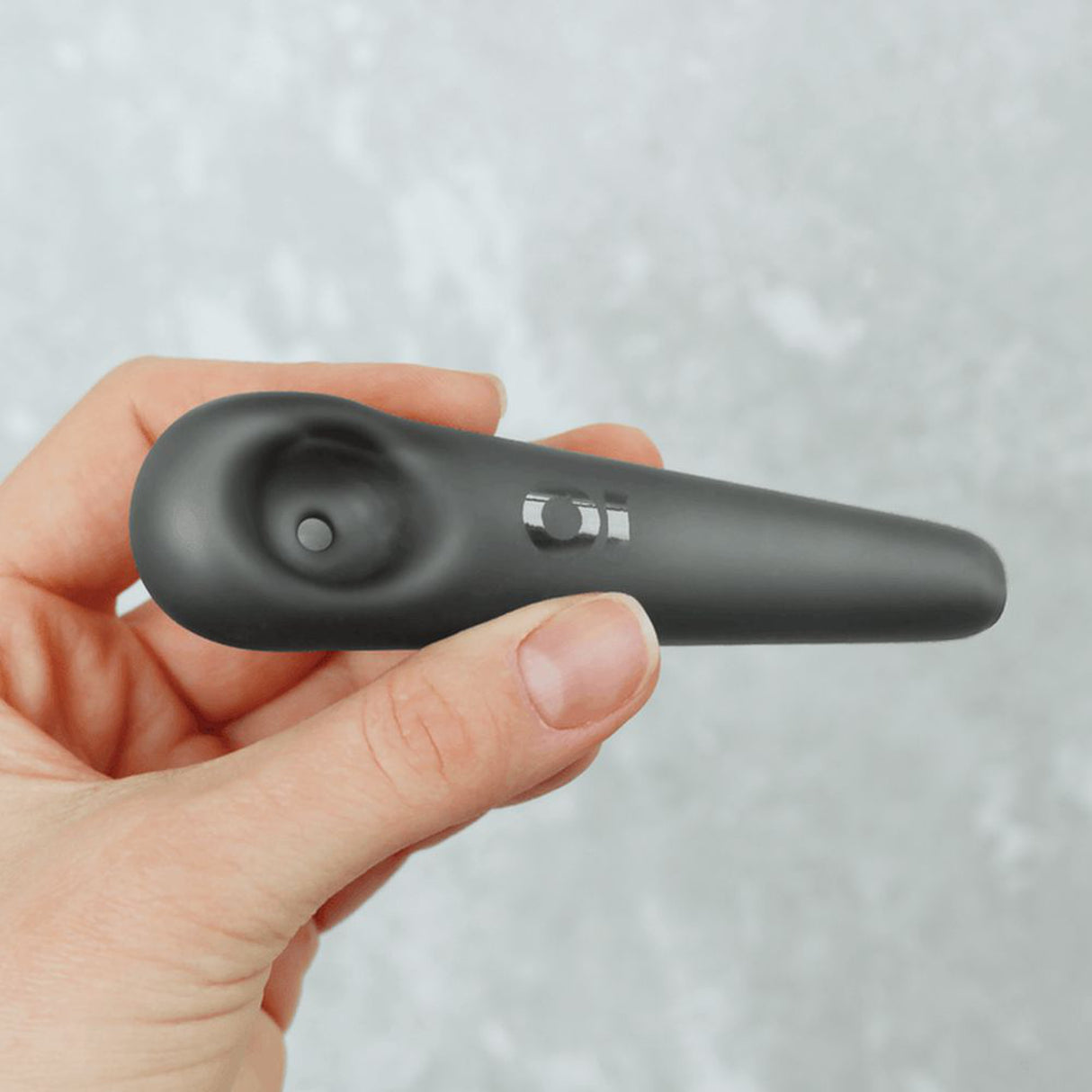 Hand holding the Glass Pipe - Frosted Teardrop Spoon, showcasing its sleek, durable borosilicate glass design with unique stable feet for enhanced functionality.