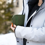 Person holding the Smell Proof Water-Resistant Wallet, showcasing its compact, durable design with a secure zipper and lock for organizing essentials.