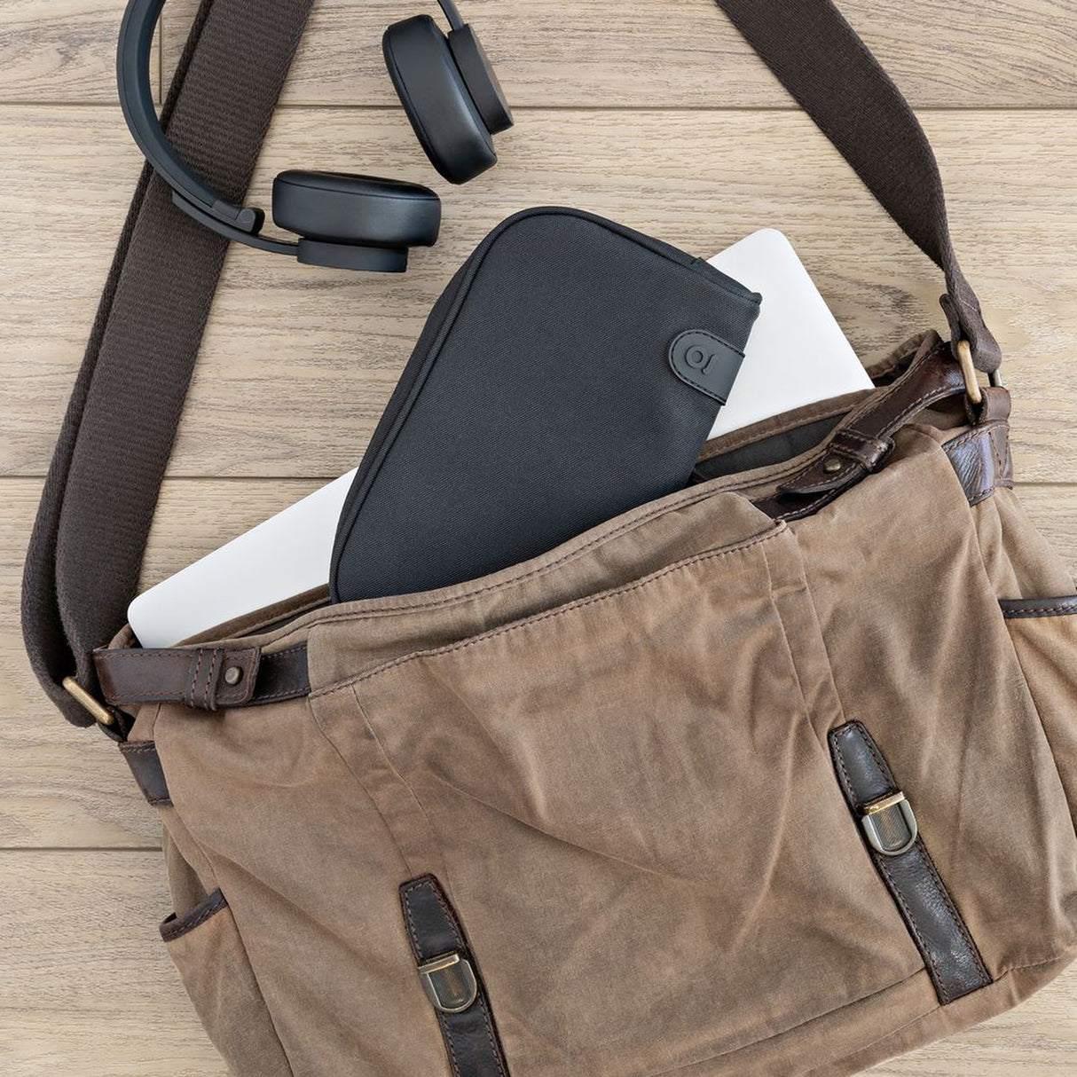 Smell Proof Water-Resistant Wallet with laptop, headphones, and buckle visible, featuring elastic webbing, compartments, and a secure combo lock for organized storage.