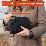 Smell Proof Water-Resistant Wallet held by a woman, showcasing its compact design. Features secure compartments and a combo lock for added security.