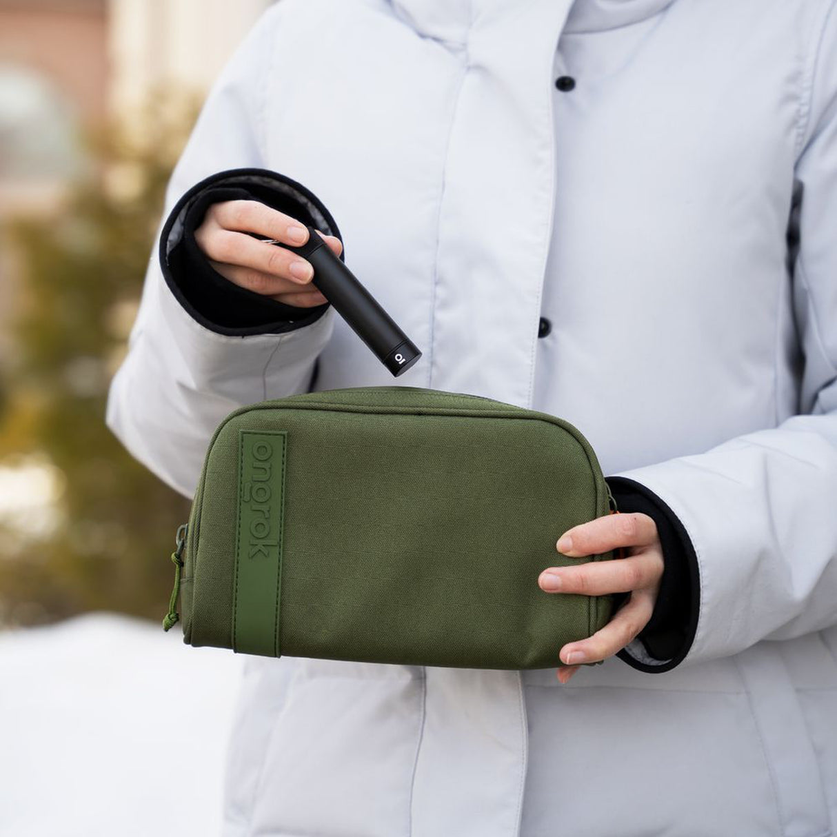 A person holds the Smell Proof Water-Resistant Wallet, showcasing its compact design, secure compartments, and durable construction with a visible hand grip.