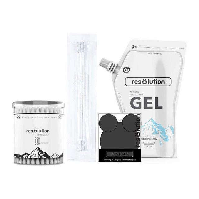 Ooze Resolution Spotless Cleaning Kit with Black Cap featuring a clear bottle, cotton swabs container, and cleaning tools for glass pipes.