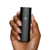 PAX Mini Dry Herb Vaporizer held in hand, showcasing its compact design and single-button operation.