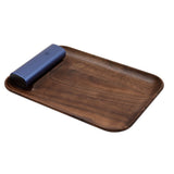 PAX Prep Tray (Walnut) featuring a dedicated slot for a blue PAX device on a smooth wooden surface, ideal for organized and stylish preparation.