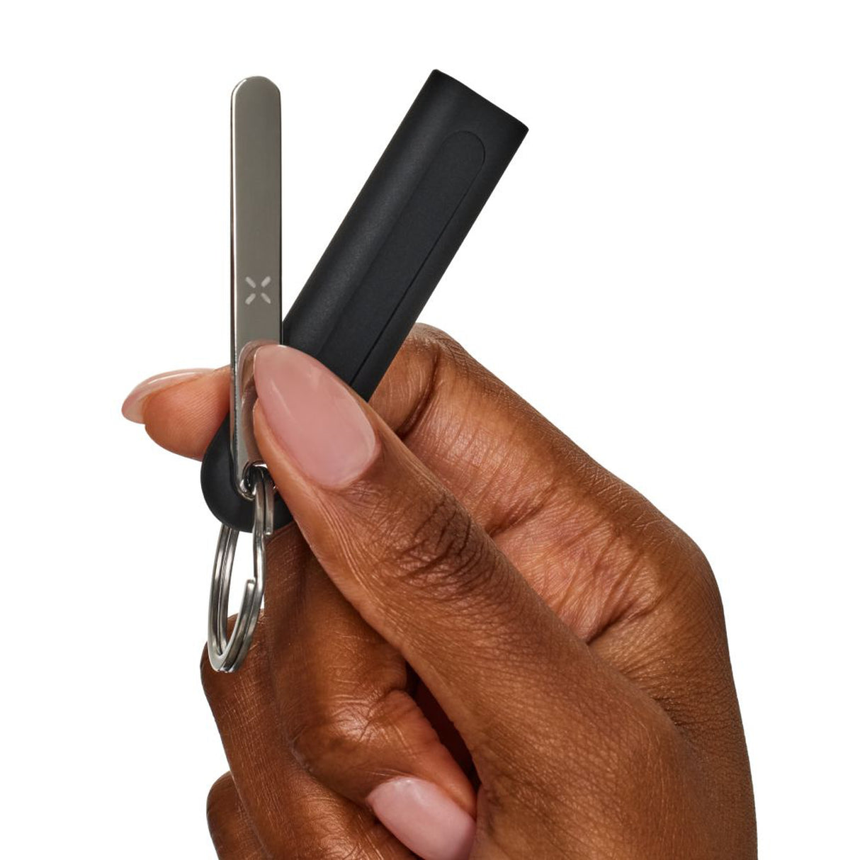 Hand holding the PAX Rounded Multi-Tool with keychain attachment, designed for easy packing and removing material from PAX Mini and PAX Plus devices.