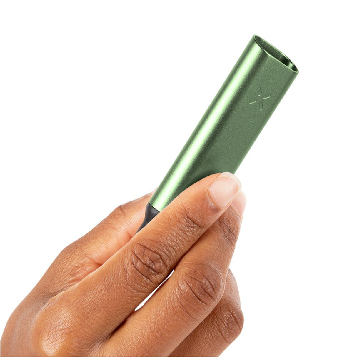 Hand holding the PAX Stash Tube (Sage), a compact, airtight container for ground material with an angled top and silicone tamp for easy packing.