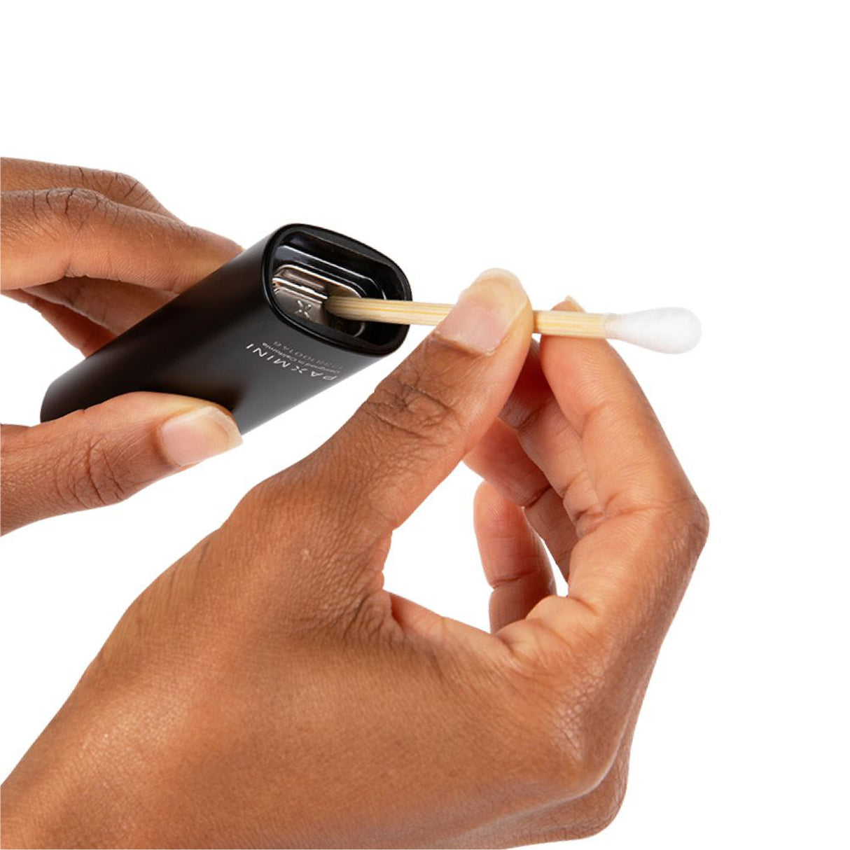 Person holding PAX Vape Cleaning Swabs (75pk) with a wooden-tipped swab designed for cleaning PAX devices, ensuring effective maintenance and residue removal.