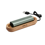 PAX Wood Charging Tray featuring a sleek wooden case and silver cylinder, designed for secure, stylish charging of PAX vaporizer models.