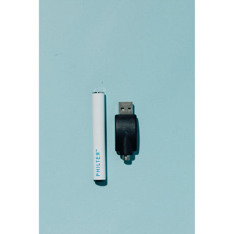 Philter Branded Buttonless 510 Thread Battery shown with USB device, illustrating its sleek design and compatibility for a seamless vaping experience.