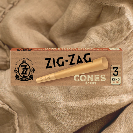 Pack of 3 Pre Rolled Unbleached King Size Cones on a cloth, featuring a distinctive crush-proof slide box for convenient portability.