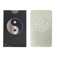 Yin Yang Grinder Card, a sleek black and silver tool with a yin yang symbol, designed for compact, portable herb grinding, fits in a wallet.