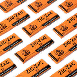 1 1/4 Orange Rolling Paper pack, close-up, showcasing smooth, slow-burning, natural flax fibers for a premium rolling experience with 50 papers per booklet.