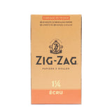 1 1/4 Unbleached Rolling Paper box, featuring Zig-Zag logo, emphasizing natural, ultra-thin, slow-burning papers for a premium smoking experience.