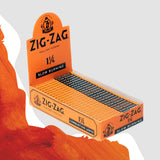 1 1/4 Orange Rolling Paper box featuring Zig-Zag branding, highlighting its natural flax plant fiber composition and slow-burning quality for a premium rolling experience.