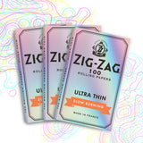 Single Wide Ultra Thin Rolling Paper, stack of booklets, highlighting Zig-Zag's logo, designed for a cleaner burn with minimal ash, crafted from natural flax fibers.