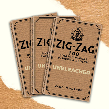 Single Wide Zig-Zag Unbleached Rolling Paper pack with black logo, featuring natural fibers and gum seal for a pure smoking experience.